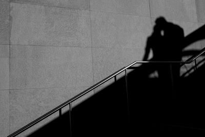 Shadow of man on railing