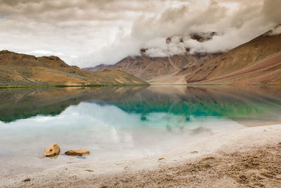 Scenic view of lake against cloudy sky