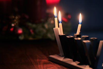 Close-up of burning candles on table