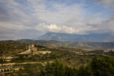 Scenic view of landscape and buildings against sky