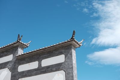Low angle view of statue against blue sky