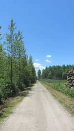 Road amidst trees against clear sky