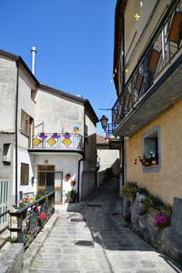 A narrow street between the old houses of marsicovetere, a village  of potenza province, italy.