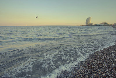 Scenic view of sea against clear sky during sunset