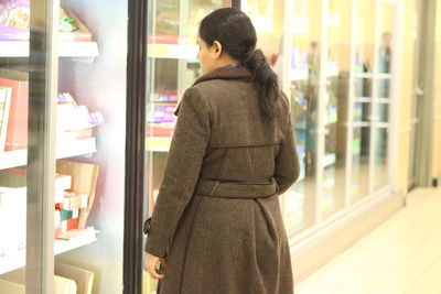 Side view of woman shopping in super market