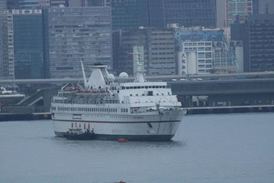 Ship in sea against buildings in city