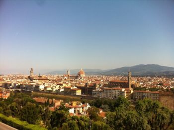 View of cityscape against blue sky