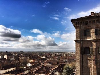 View of city against cloudy sky