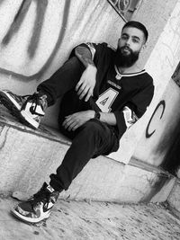 High angle portrait of man sitting on skateboard