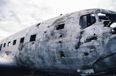 Abandoned airplane against sky