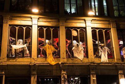 People in illuminated building at night