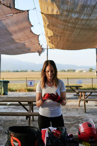 Young fit woman taking her gloves off outdoors