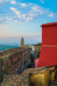 Buildings by sea against sky in city