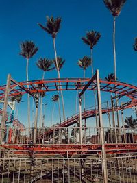 Low angle view of ferris wheel against blue sky