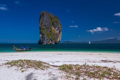 Scenic view of rock formation on beach against sky