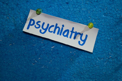 High angle view of warning sign on blue background