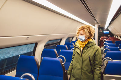 Full length of woman sitanding in a train