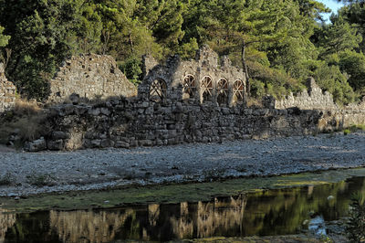 View of stone wall with trees in background