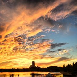 Scenic view of sea against cloudy sky at sunset