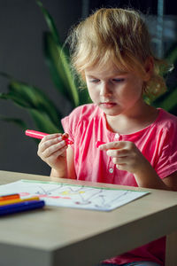 Boy drawing on book