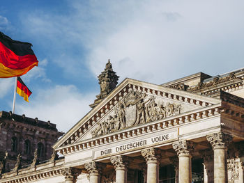 Low angle view of flags against sky