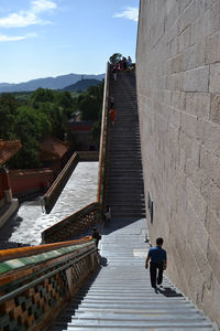 Rear view of people walking on staircase