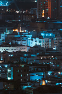 High angle view of illuminated buildings in city at night