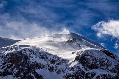 Scenic view of snow covered mountains against sky