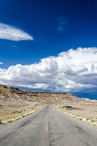 Empty road along countryside landscape