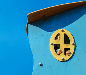 Low angle view of rusty metal against blue sky