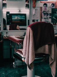 Rear view of man sitting on chair at home