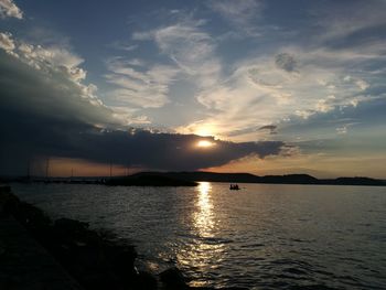 View of sea against cloudy sky during sunset