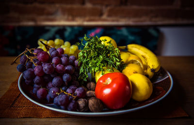 Close-up of various fruits in plate on table