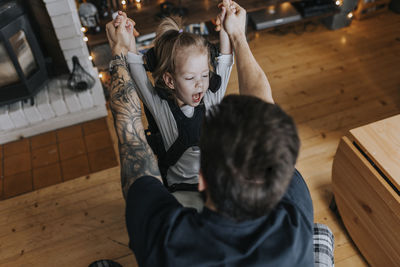 Father playing with disabled child in wheelchair