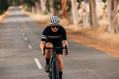 Woman riding bicycle on road