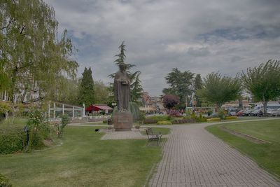 Statue in park against sky