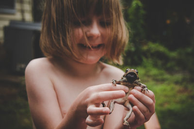 Close-up of woman holding girl outdoors