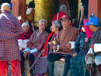 People in traditional clothing standing outdoors