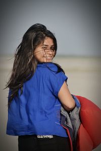 Close-up of girl against sky