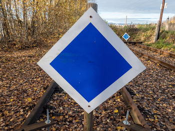 Wooden buffer stop with blue sign stop. sign ending rail tracks for limit, limitation restrication