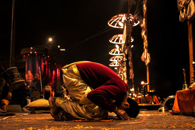 Side view of man praying at temple