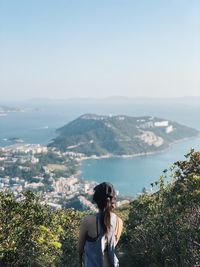 Woman looking at mountain against sky