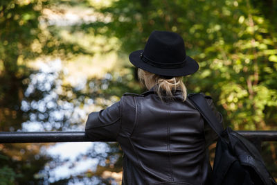 Side view of woman wearing hat standing outdoors