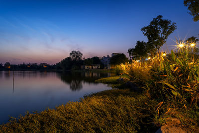 Scenic view of lake against sky at sunset