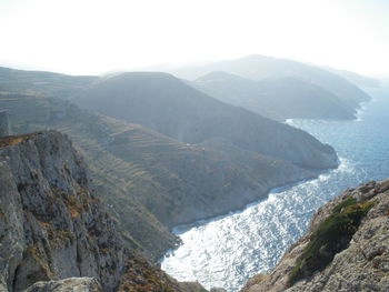 High angle view of sea and mountains against sky