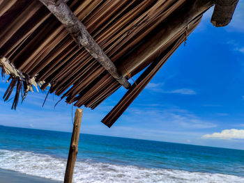 Lifeguard hut on beach against sky