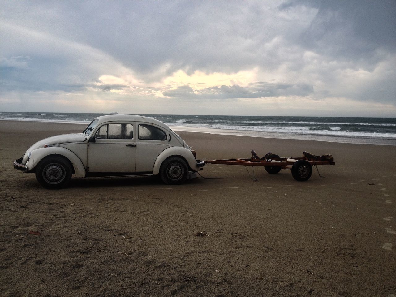 sky, transportation, sea, mode of transport, horizon over water, beach, cloud - sky, land vehicle, sand, cloudy, shore, cloud, tranquility, water, nature, abandoned, car, stationary, scenics, outdoors