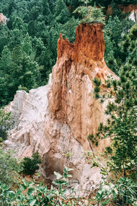 Rock formation and trees against sky