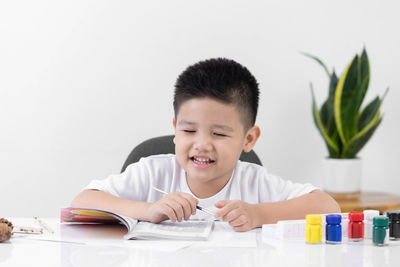 Portrait of cute boy looking at table