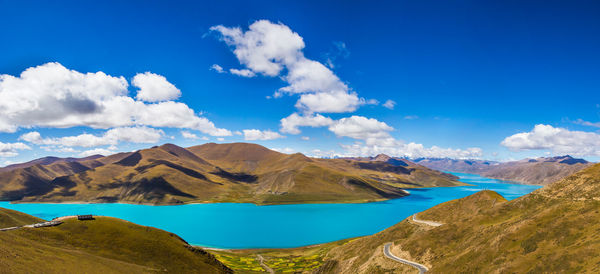 Panoramic view of lake and mountains against blue sky